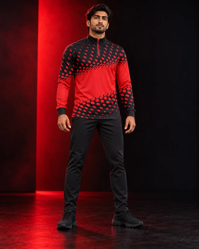 Close view of the red and black printed quarter-zip garment